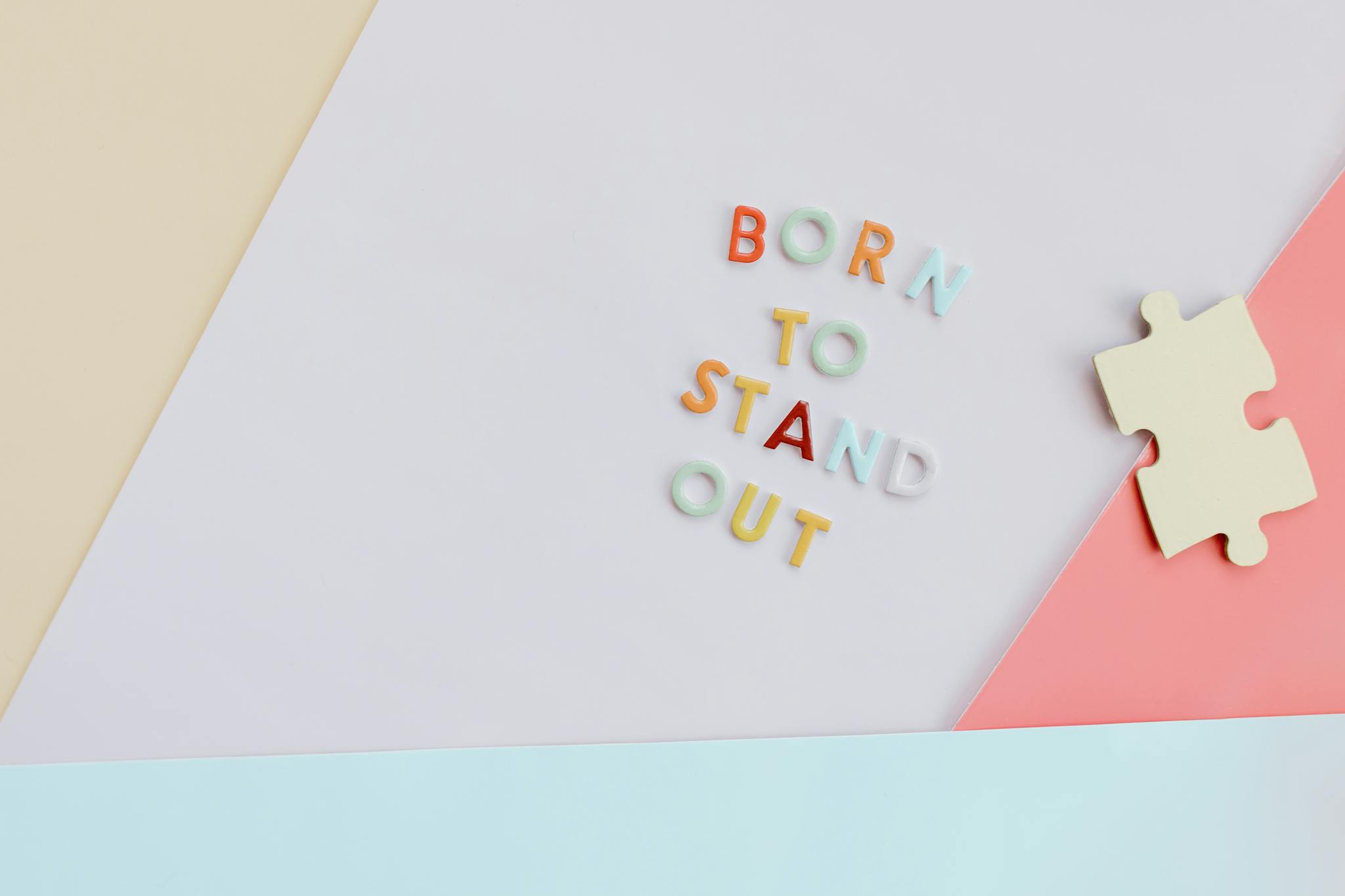 Vibrant conceptual image featuring 'Born to Stand Out' with a puzzle piece, symbolizing autism awareness.